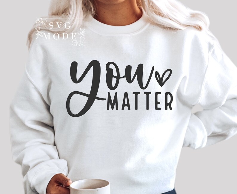 May include: White sweatshirt with black text that reads "you matter" with a small heart symbol.