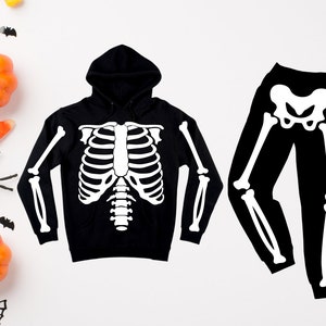 May include: Black skeleton hoodie and matching trousers. The hoodie has a white skeleton design on the front and the trousers have a white skeleton design on the legs.