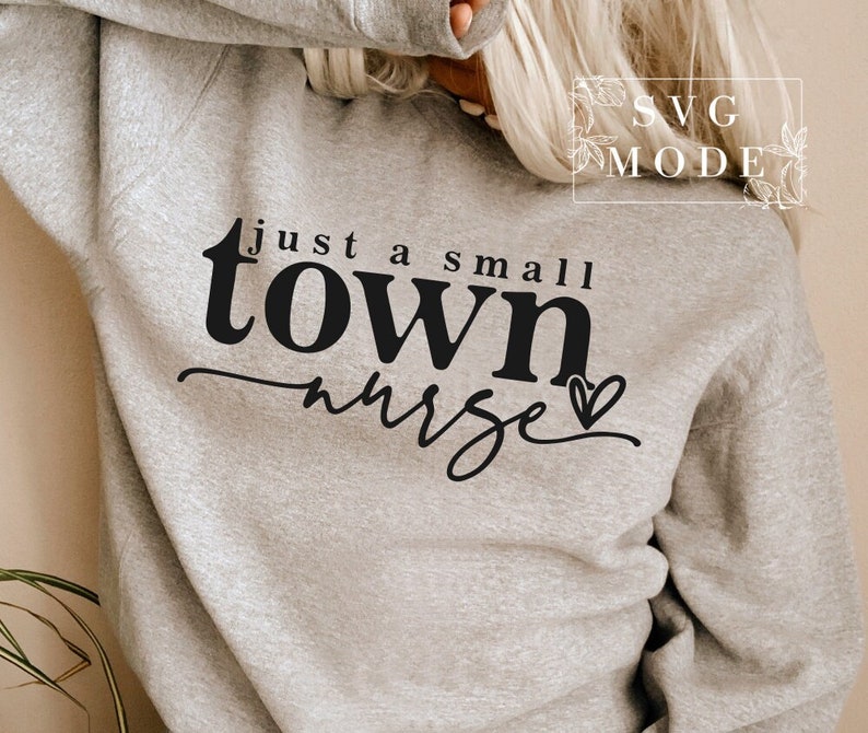 May include: A gray sweatshirt with the text "just a small town nurse" in black lettering with a small heart.