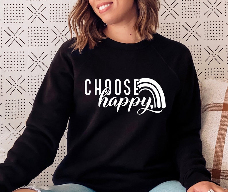 May include: Black sweatshirt with white text that reads "Choose happy" and a rainbow graphic.