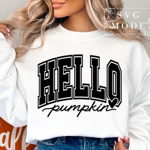 Może przedstawiać: Biała bluza z czarnym napisem "HELLO pumpkin" z małym sercem po słowie pumpkin.