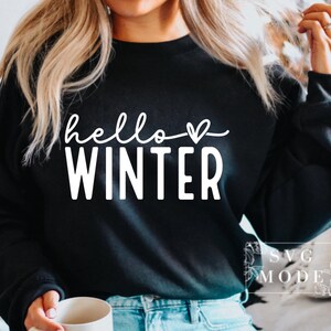 May include: A black sweatshirt with the text "hello winter" in white with a small heart symbol.