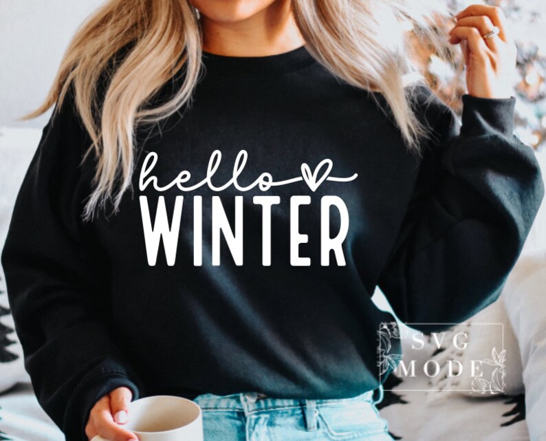 May include: A black sweatshirt with the text "hello winter" in white with a small heart symbol.
