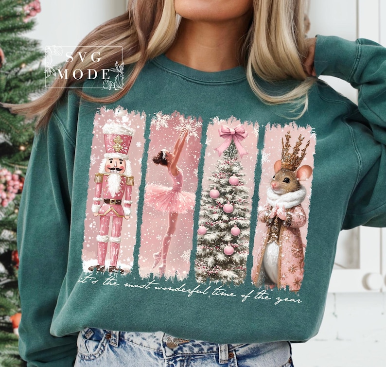 K&ouml;nnte beinhalten: Ein t&uuml;rkisfarbener Pullover mit einem weihnachtlichen Design, das einen Nussknacker, eine Ballerina, einen Weihnachtsbaum und eine Maus mit Krone zeigt. Der Text "It's the most wonderful time of the year" ist auf dem Pullover aufgedruckt.