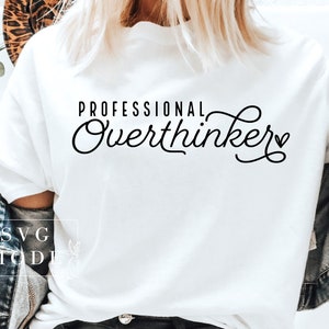 May include: White t-shirt with black text that reads "Professional Overthinker" with a small heart symbol.