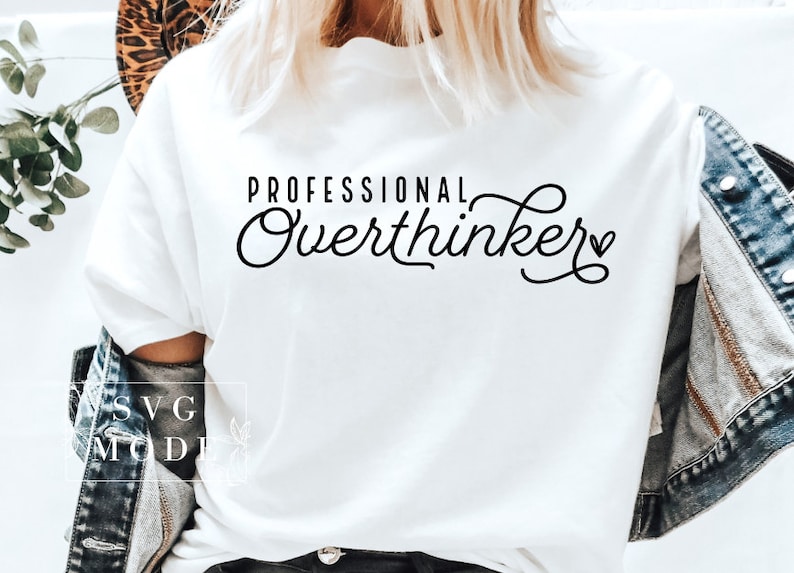May include: White t-shirt with black text that reads "Professional Overthinker" with a small heart symbol.