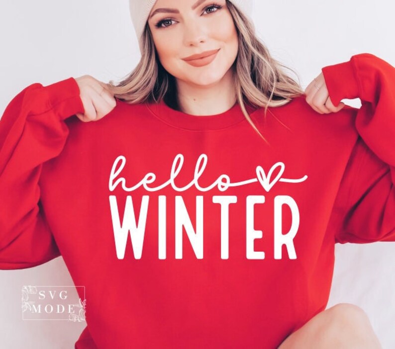 May include: Red sweatshirt with white text that says "hello winter" with a small heart symbol.