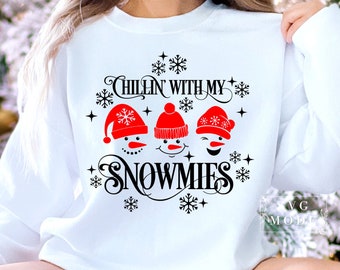 May include: White sweatshirt with a black and red graphic design featuring three snowmen with the text "Chillin with my Snowmies".