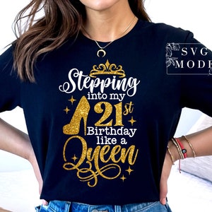 Pode incluir: Camiseta preta com um design dourado brilhante. O design inclui o texto "Stepping into my 21st Birthday like a Queen" com um salto alto e um gr&aacute;fico de coroa. A camiseta &eacute; de gola redonda.