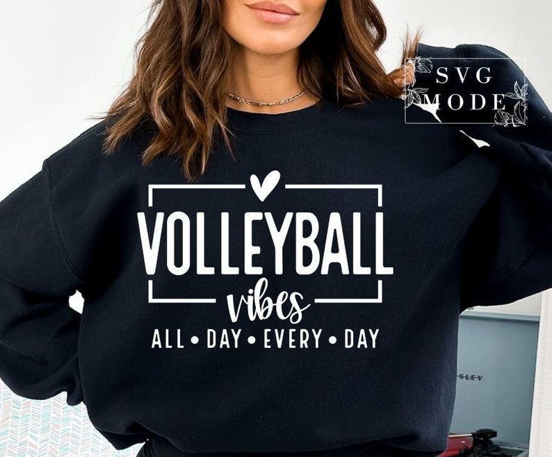 May include: Black sweatshirt with white text that reads "Volleyball vibes all day every day" with a heart above the word "Volleyball".