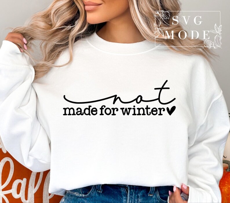 May include: White sweatshirt with black text that reads "not made for winter" with a small black heart.