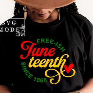 以下が含まれることがあります： 赤いハートが付いた、赤、黄、緑の文字で「Free-ish Juneteenth Since 1865」と書かれた黒いTシャツです。