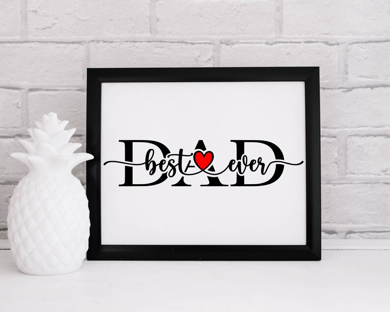 May include: Black and white framed print with the text "DAD best ever" in a cursive font. A red heart is incorporated into the "A" of DAD.