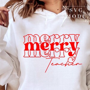 May include: White hoodie with red text that reads "merry merry teacher" in a retro font.