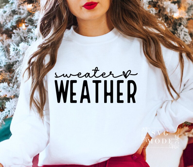 May include: White sweatshirt with black text that reads "sweater weather" with a small heart symbol.
