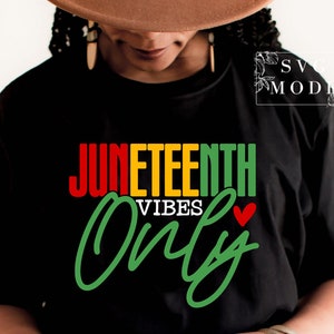 May include: Black t-shirt with the text "Juneteenth Vibes Only" in red, yellow, and green lettering with a small red heart.