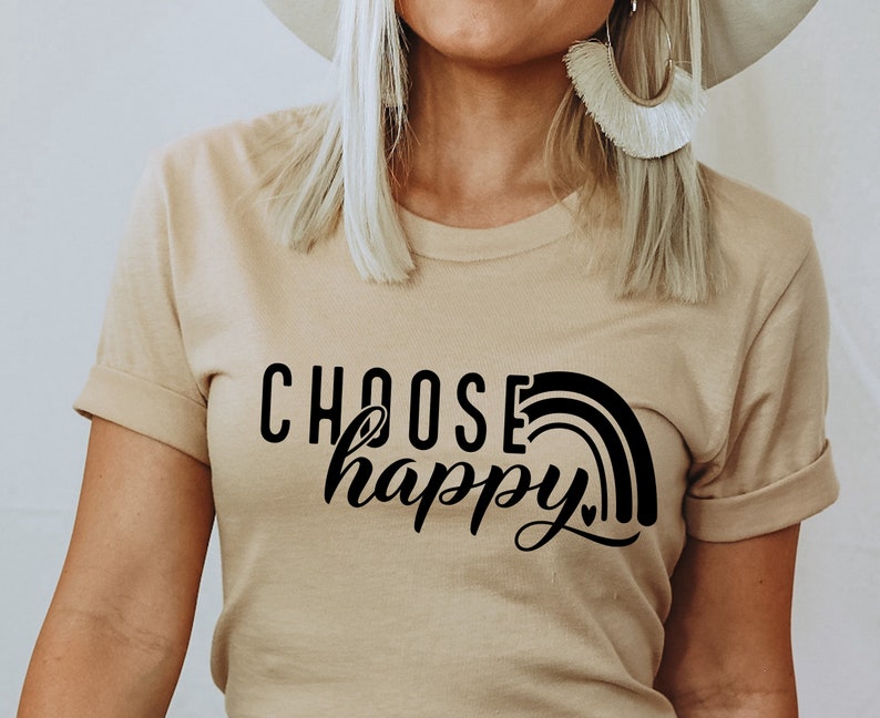 May include: A beige t-shirt with a black graphic that says "Choose happy" with a rainbow design.