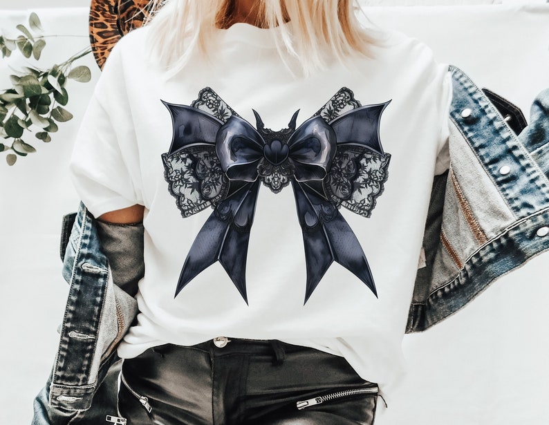May include: A white t-shirt with a large black lace bow design. The bow is made of satin ribbon and has a delicate lace trim.