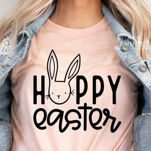 May include: A pink t-shirt with a black bunny rabbit graphic and the text "Happy Easter" in black.