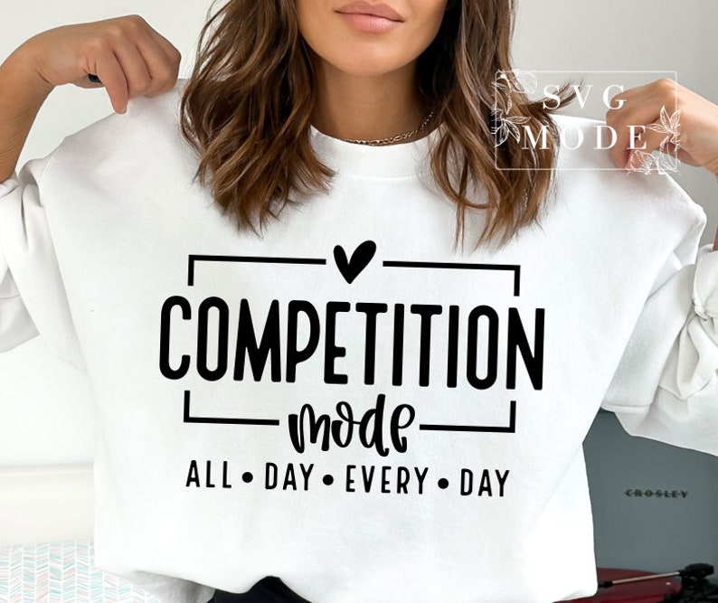 May include: White sweatshirt with black text that reads "Competition Mode" with a heart above the word "Competition" and "All Day Every Day" below the word "Mode".