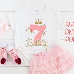 May include: A white t-shirt with a pink number seven and gold crown and text that says "My 7th Birthday".