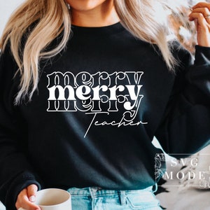 May include: Black sweatshirt with white text that reads "merry merry teacher" in a retro font.