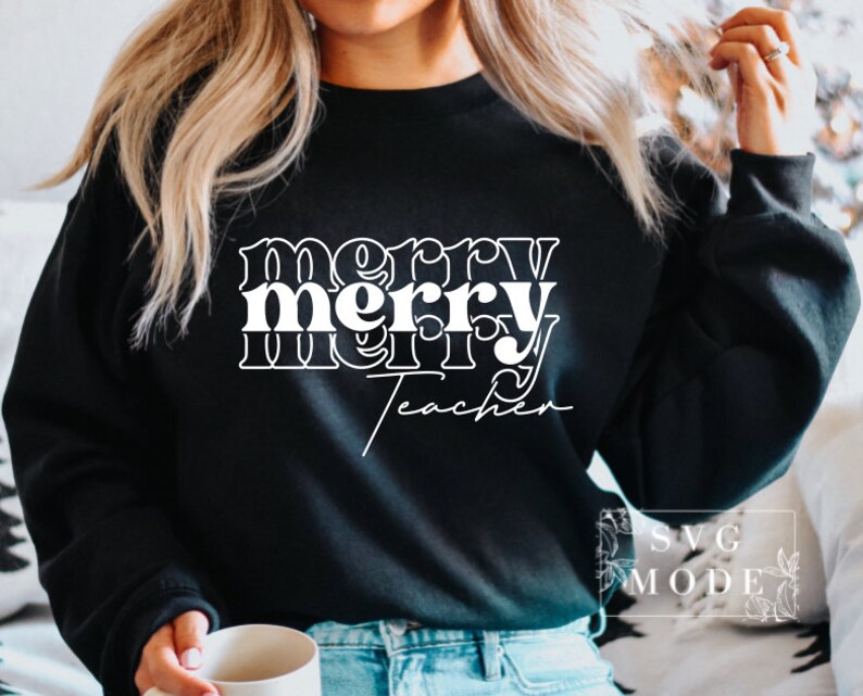 May include: Black sweatshirt with white text that reads "merry merry teacher" in a retro font.