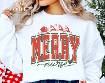 May include: White sweatshirt with a red and green graphic that says "Merry Nurse" with a small heart. The graphic also includes a red sleigh with Santa and reindeer.