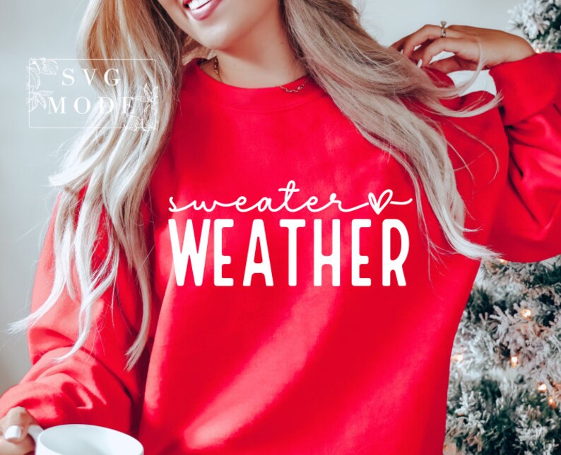 May include: Red sweatshirt with white text that says "sweater weather" with a small heart symbol.