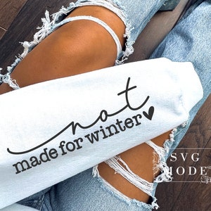 May include: A white sweatshirt with the text "not made for winter" and a small heart.