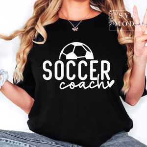 May include: A black t-shirt with a white football graphic and the text "SOCCER coach" with a heart.