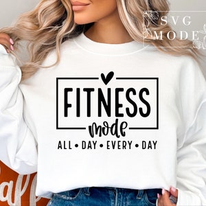 May include: White sweatshirt with a black graphic that says "Fitness mode" with a heart above the text and "All Day Every Day" below the text.