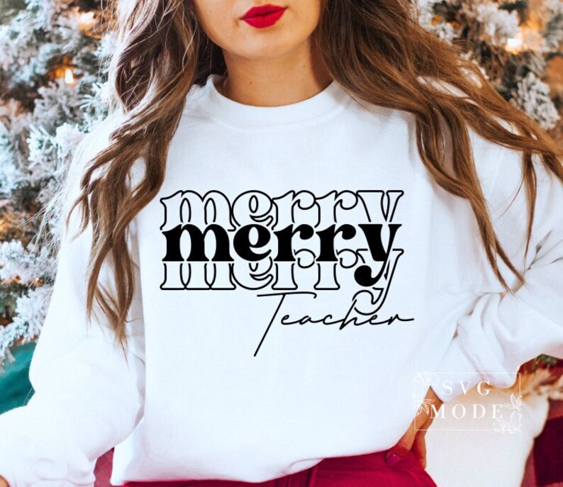 May include: White sweatshirt with black text that reads "merry teacher" in a stylized font.