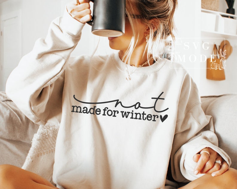 May include: A white sweatshirt with the text "not made for winter" in black lettering and a small heart.