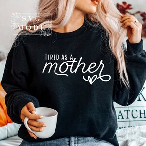 May include: Black sweatshirt with white text that reads "Tired as a mother" with a small heart.