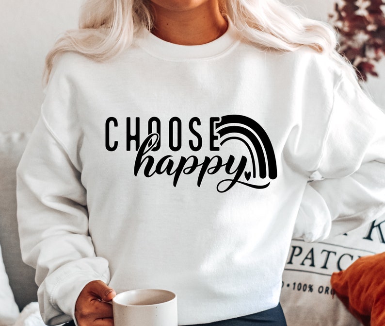May include: White sweatshirt with black text that reads "Choose happy" and a rainbow graphic.