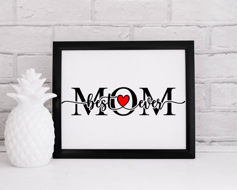 May include: Black and white framed print with the text "MOM best ever" in a cursive font with a red heart in the middle of the word "MOM".