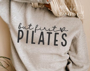 May include: Grey sweatshirt with the text "but first PILATES" in black with a small heart symbol.