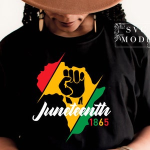May include: Black t-shirt with a graphic of a raised fist in front of a red, yellow, and green silhouette of Africa. The text "Juneteenth 1865" is below the graphic.