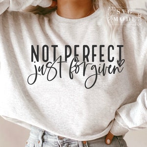 May include: A gray sweatshirt with the text "NOT PERFECT just forgiven" in black lettering with a small heart.
