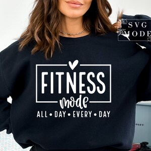May include: Black sweatshirt with white text that reads "Fitness Mode All Day Every Day" with a small heart above the word "Fitness".