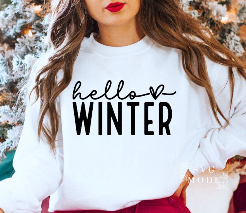 May include: White sweatshirt with black text that says "hello winter" with a small heart symbol.