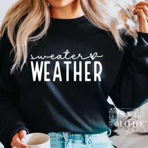 May include: A black sweatshirt with the text "sweater weather" in white with a small heart symbol.