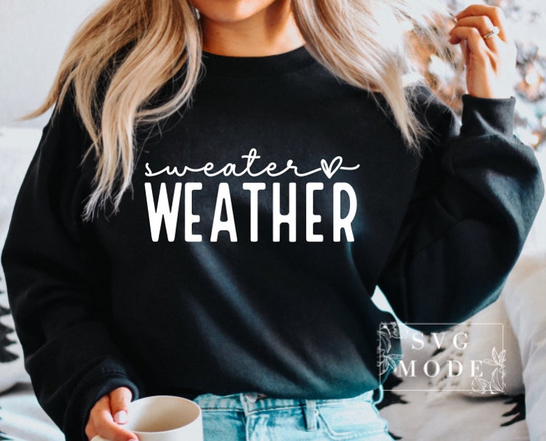 May include: A black sweatshirt with the text "sweater weather" in white with a small heart symbol.