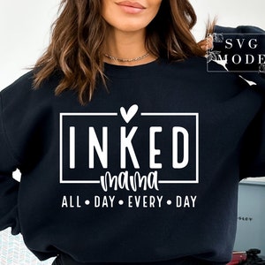 May include: Black sweatshirt with white text that reads "INKED mama ALL DAY EVERY DAY" with a small heart above the word "INKED".