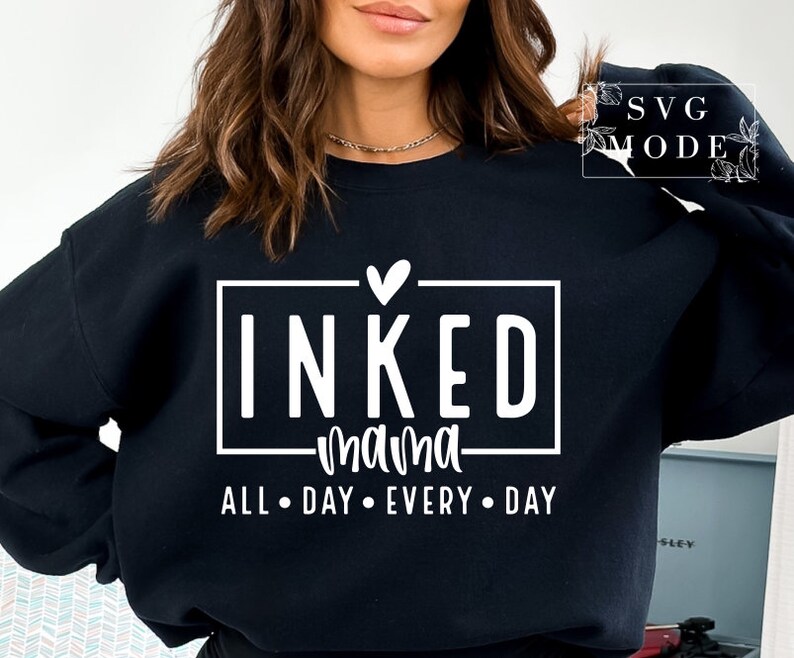 May include: Black sweatshirt with white text that reads "INKED mama ALL DAY EVERY DAY" with a small heart above the word "INKED".