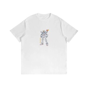 May include: White t-shirt featuring a colorful illustration of a robot-like figure. The graphic includes details in yellow, red, and blue. The design is centered on the front of the shirt, offering a bold statement. A casual and comfortable apparel item.