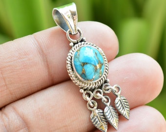 May include: A silver pendant with a turquoise stone and three dangling leaves. The stone has a blue and green color with gold flecks.