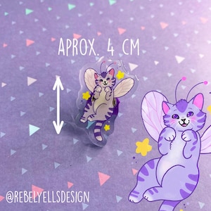 May include: Purple and white fairy cat sticker with wings and stars. The sticker is approximately 4 cm in size.  @rebelyellsdesign