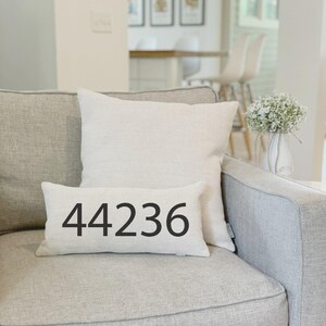 May include: A set of three ceramic mugs with a speckled, matte finish. The mugs are in shades of cream, light gray, and dark gray. Each mug has a simple, minimalist design and a rounded handle.